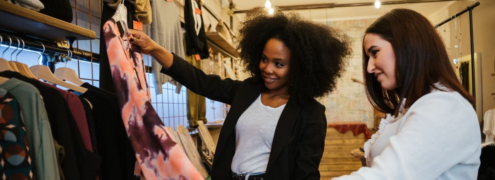 Two women browsing clothing at boutique